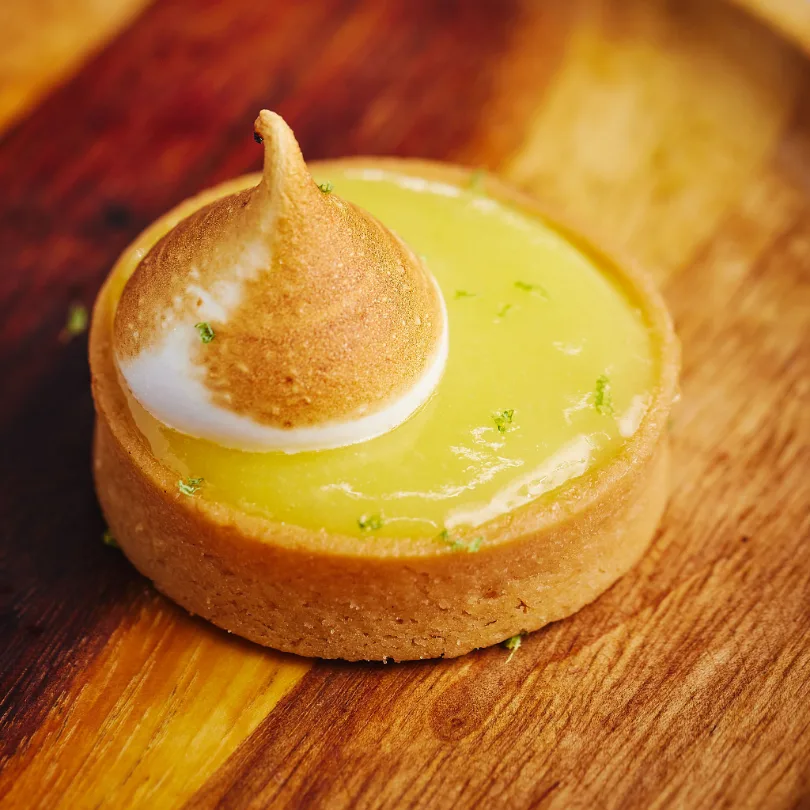 Lemon meringue tart from cat in the hat: lemon curd in a shortcrust shell, torched meringue quenelle and lime zest