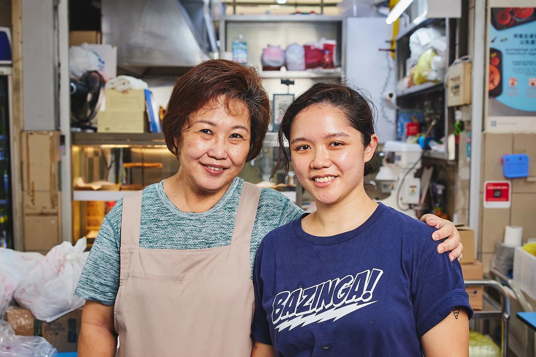 The mother-and-daughter team behind cat in the hat, in aprons at their stall in Golden Mile Food Centre